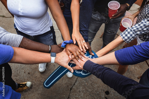 Sports fans in a huddle at a tailgate event photo