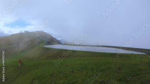 Fog drifts over a beautiful small reservoir on the mountain Asitz Kogel in Austria, Leogang Saalbach photo