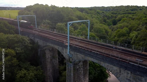 Flying Scotsman Steam Train passes over Pegswood Viaduct, Morpeth, Northumberland. Dolly shot. photo
