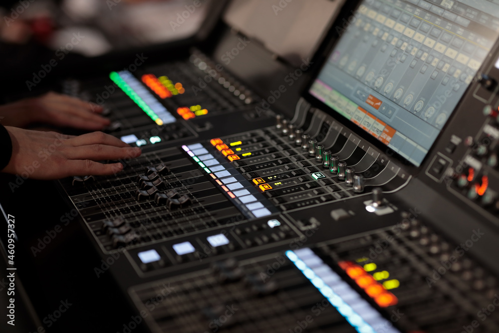 sound engineer at work with digital mixing console