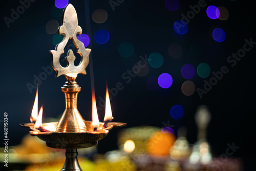 Large Golden Brass Panchmukhi Diya Deep Illuminated With Blur Bokeh Effect Background For Diwali Puja New Year Deepawali Or Shubh Deepavali Navratra Pooja Festival Celebration photo