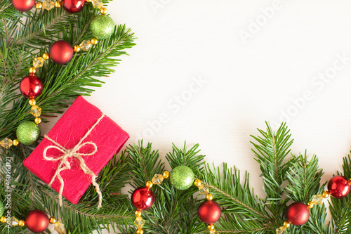 Christmas gift and decoration on Christmas tree branches, on a white background, layout