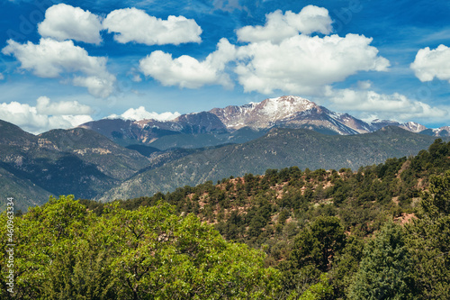 Pikes Peak Colorado under a blue sky with pillowy clouds.