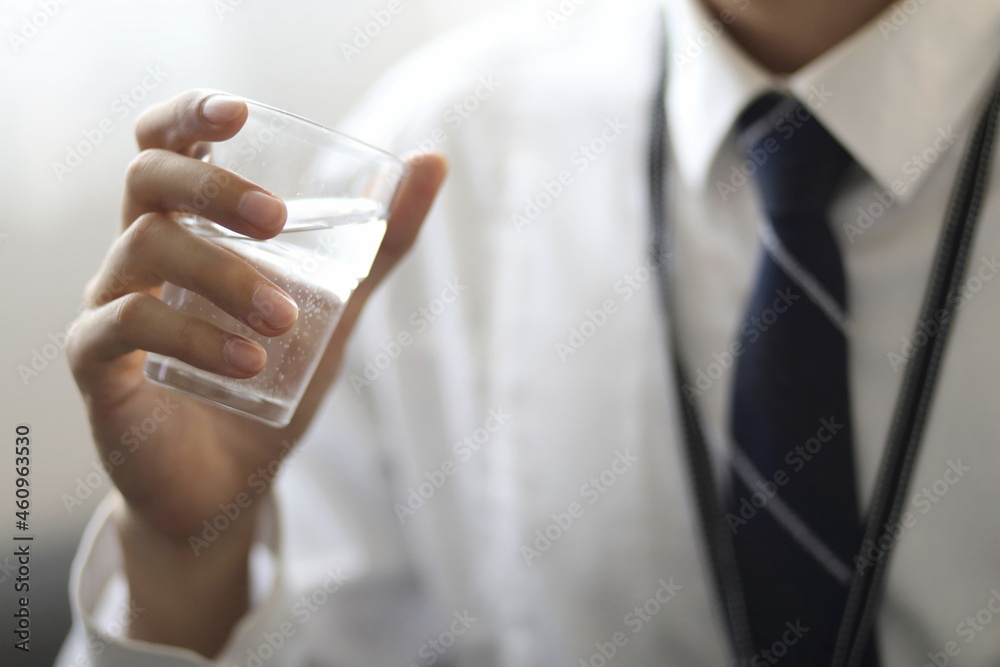 Businessman drinking water in office
