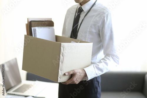 Fired businessman carrying box of personal items © 상은 신