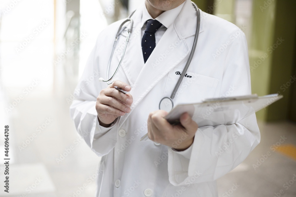 Close up of doctor reviewing medical chart Close up of doctor reviewing medical chart