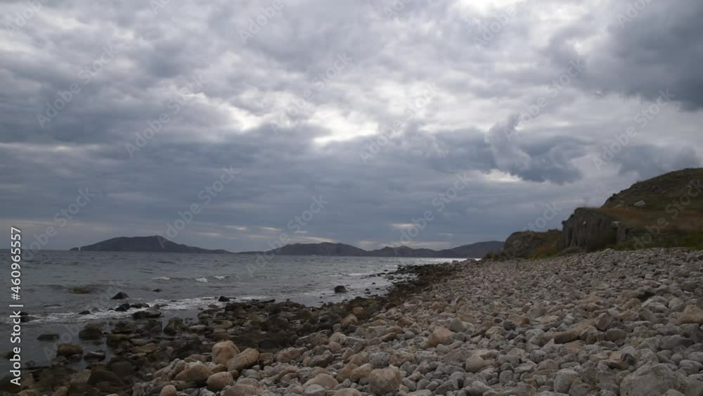 Cloudy seascape in Crimea with mountains and stones