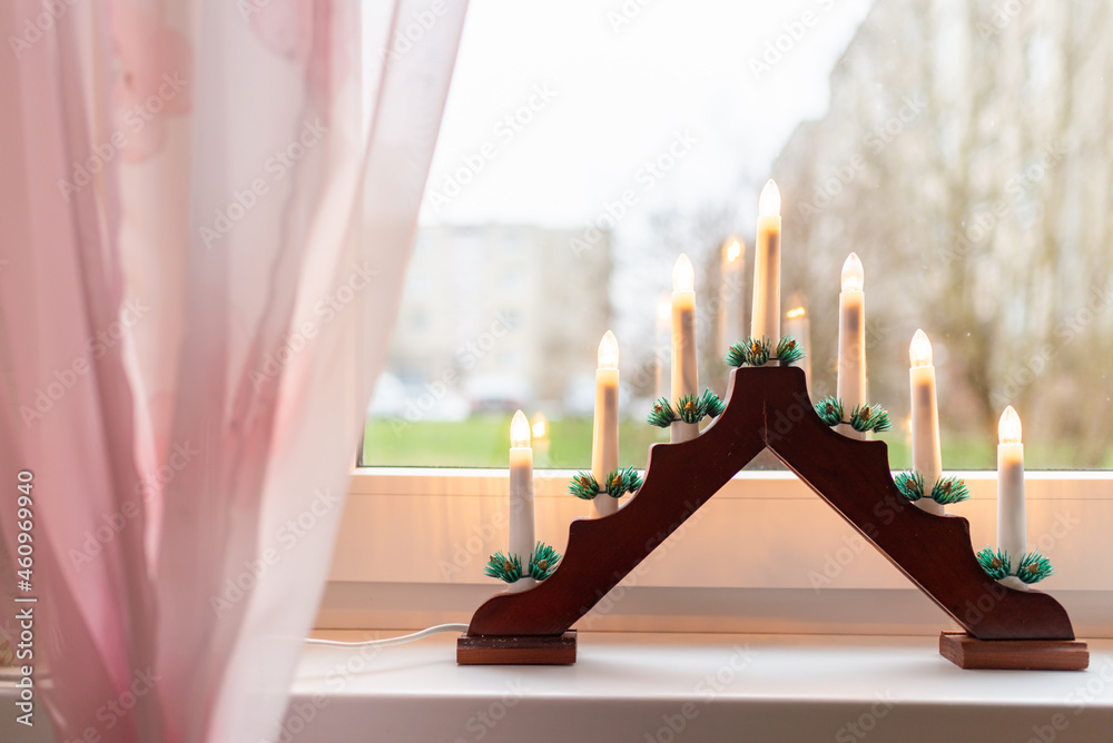 Advent electric candles on window sill.electrical advent candles by the