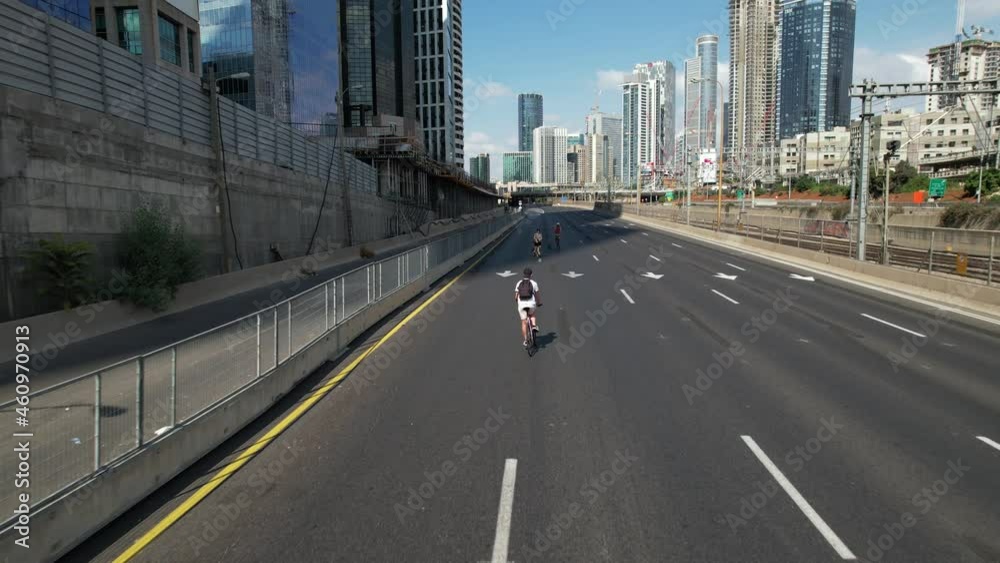 Aerial drone view following a person cycling on a empty highway in Tel Aviv, Israel, during Yom Kippur Aerial drone view following a person cycling on a empty highway in Tel Aviv, Israel, during Yom Kippur