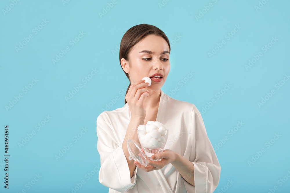 Beautiful young woman with cotton wool on color background Beautiful young woman with cotton wool on color background