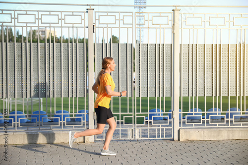 Sporty mature woman running outdoors