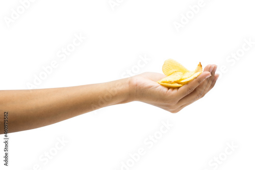 Hand holds potato chips. Isolated on a white background.