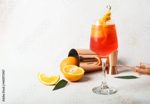 Glass of Aperol spritz cocktail on light background photo