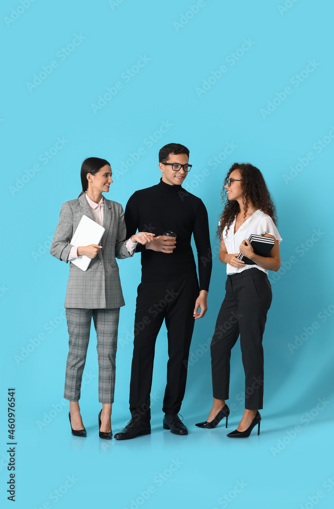 Fototapeta premium Young business people on blue background