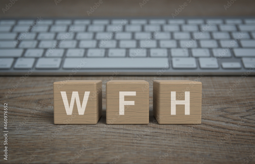 WFH acronym on block cubes on wooden table with computer keyboard, Business work from home online concept WFH acronym on block cubes on wooden table with computer keyboard, Business work from home online concept