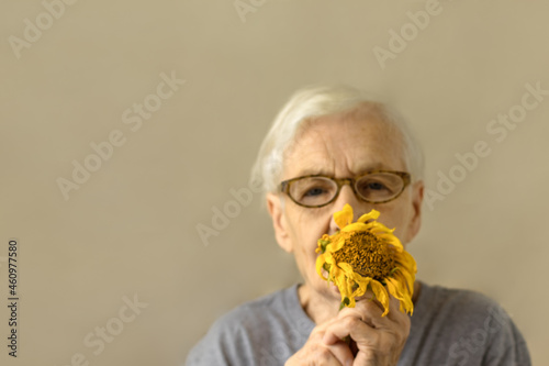 Elderly  woman with sunflower . lifestyle . Concept mother day. photo