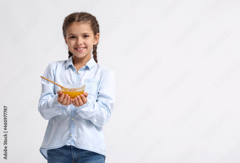 Little girl with honey on white background Little girl with honey on white background