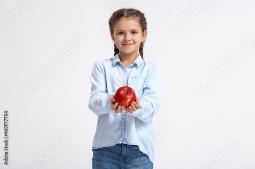 Little girl with apple on w...