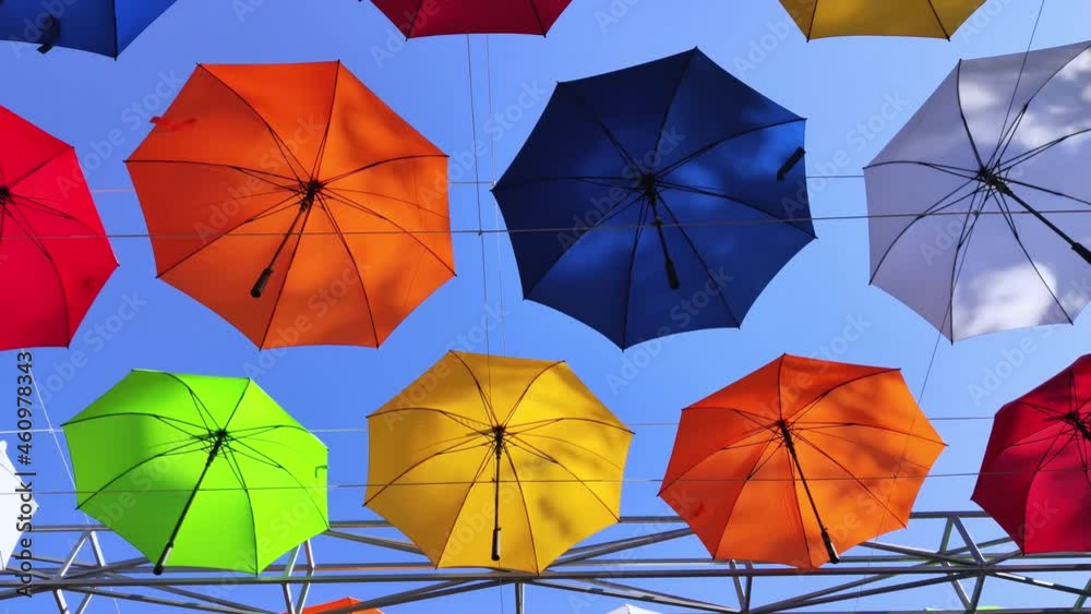 Colorful umbrellas. Bottom view. Conceptual art object. No labels or identification marks. Place for your text. Colorful background. Concept of a good mood and protection from problems. Sky is visible Colorful umbrellas. Bottom view. Conceptual art object. No labels or identification marks. Place for your text. Colorful background. Concept of a good mood and protection from problems. Sky is visible