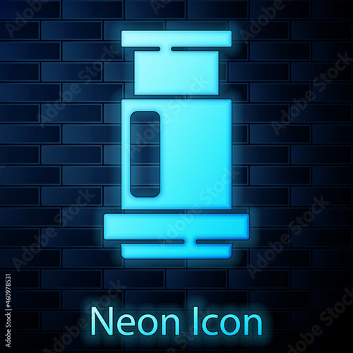 Glowing neon Aeropress coffee method icon isolated on brick wall background. Device for brewing coffee. Vector