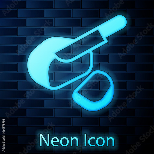 Glowing neon Canadian peameal bacon icon isolated on brick wall background. Vector