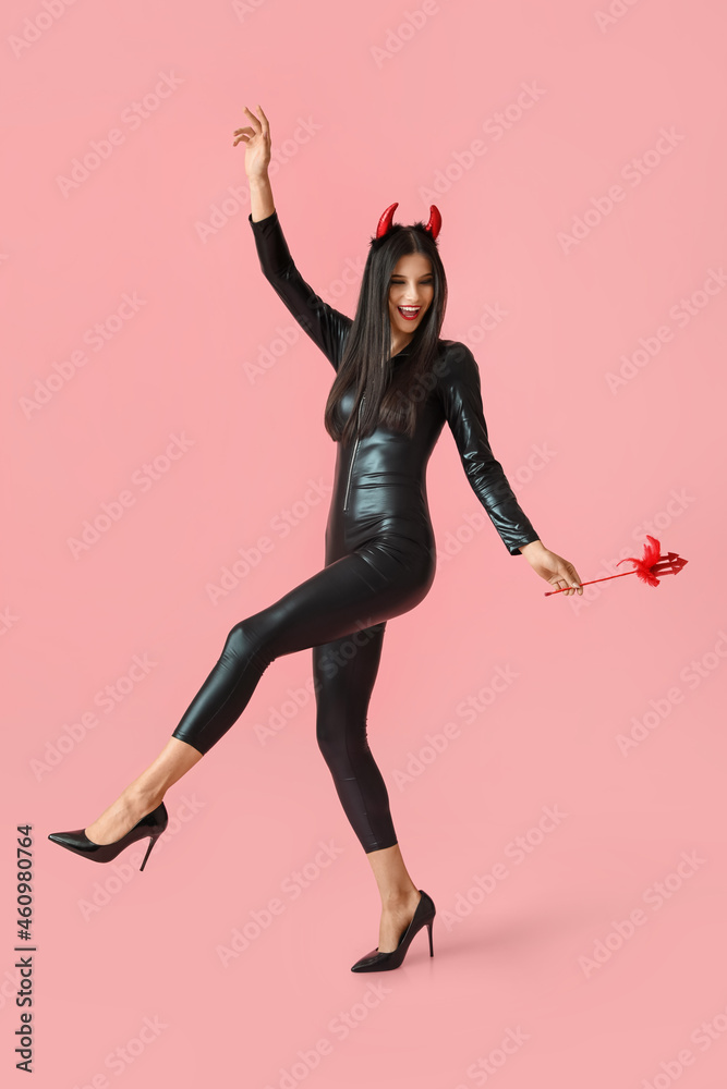 Beautiful young woman in Halloween costume on color background