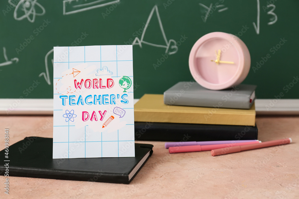 Composition with greeting card on table in classroom. Teacher's Day celebration Composition with greeting card on table in classroom. Teacher's Day celebration