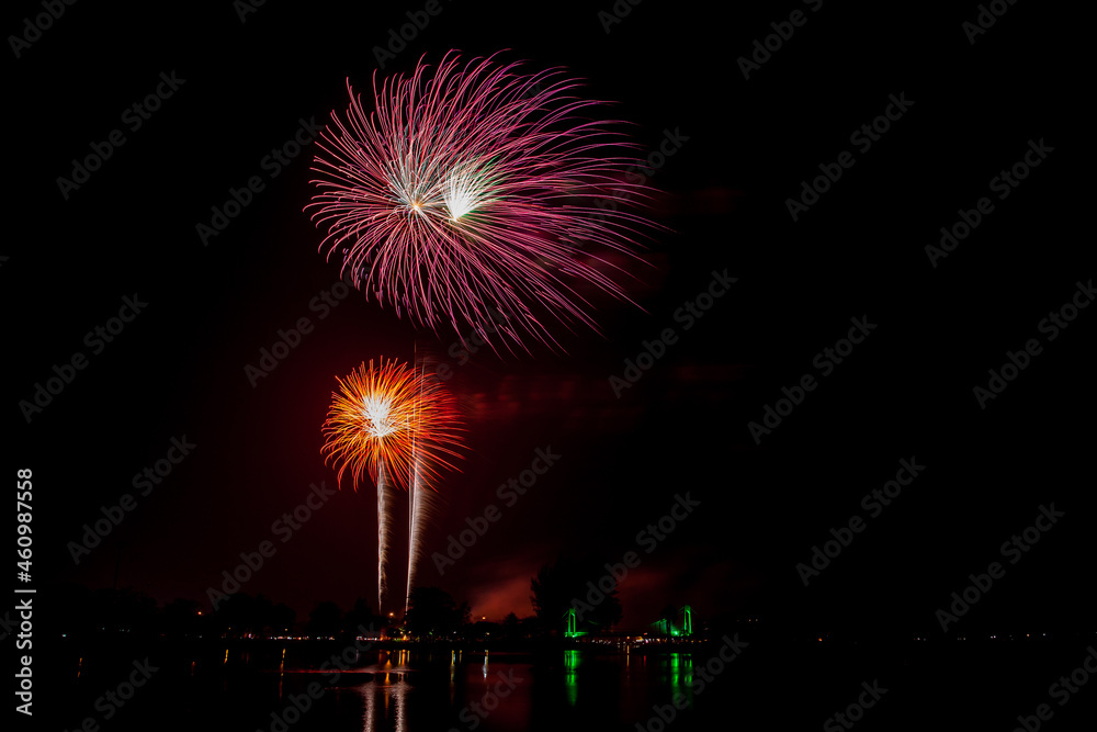 Fireworks with beautiful colorful flowers on a dark sky background.