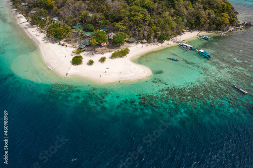 Aerial seascape tropical island and sand beach, turquoise water and coral reef. Malacory island in Palawan, Philippines. photo