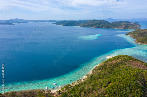 Aerial seascape tropical island and sand beach, turquoise water and coral reef. Malacory island in Palawan, Philippines. © Timelapse4K