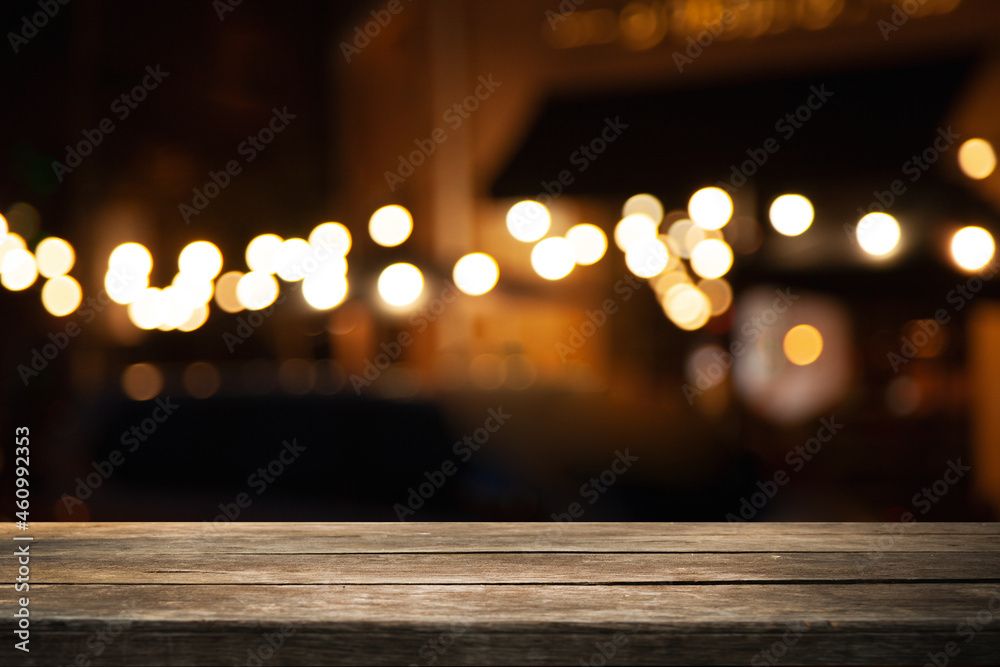 empty wooden brown table on blurred light gold bokeh cafe restaurant bar, place for your products on the table. Abstract background empty wooden brown table on blurred light gold bokeh cafe restaurant bar, place for your products on the table. Abstract background