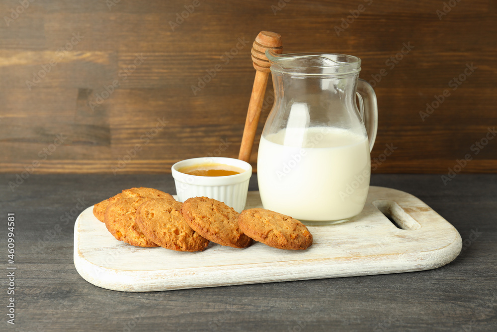 Milk, honey and pumpkin cookies on gray wooden table Milk, honey and pumpkin cookies on gray wooden table
