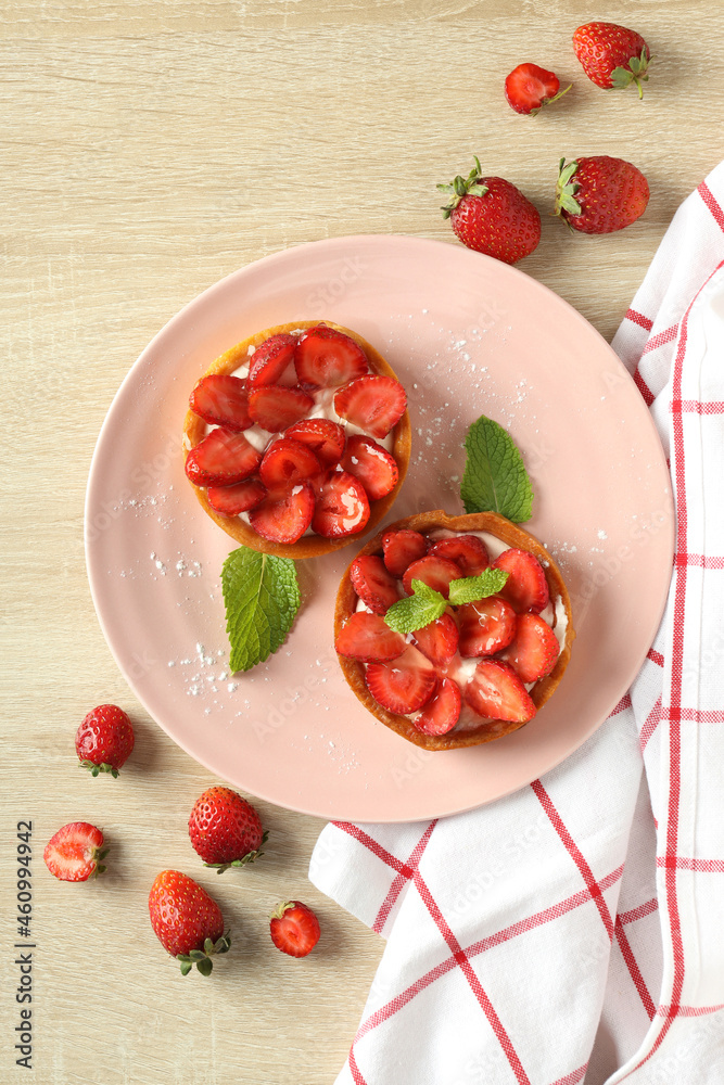 Concept of tasty food with strawberry tart on wooden table Concept of tasty food with strawberry tart on wooden table