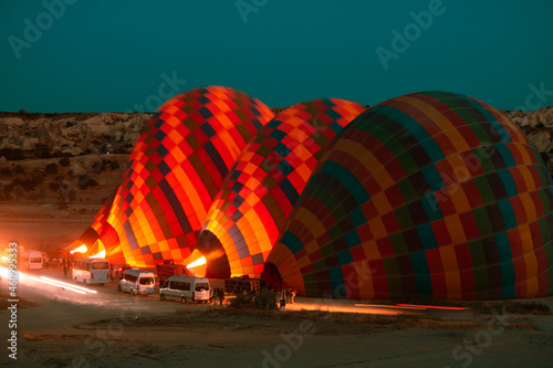 Hot air balloons are getting ready to fly at sunrise in Cappadocia Turkey