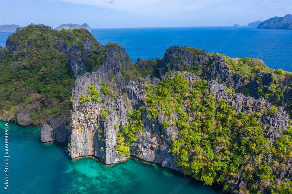 Aerial drone view azure sea and of tourist boats around the beautiful big and small lagoons in El Nido, Palawan, Philippines.