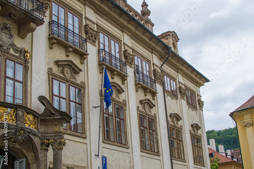 Facade of a classic building of Prague, Czech Republic, with an european flag