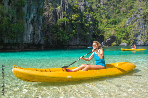 Woman on a kayak in the Small Lagoon with azure water, El Nido, Palawan, Philippines. © Timelapse4K