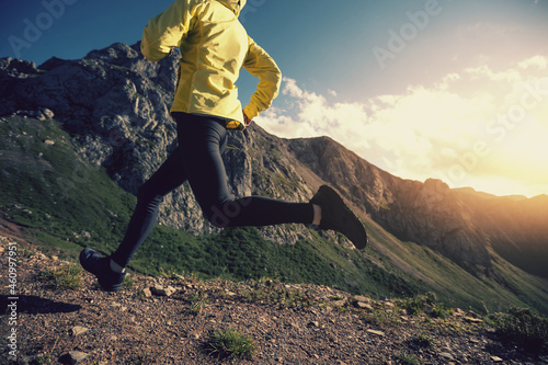 Woman trail runner running on mountain top © lzf