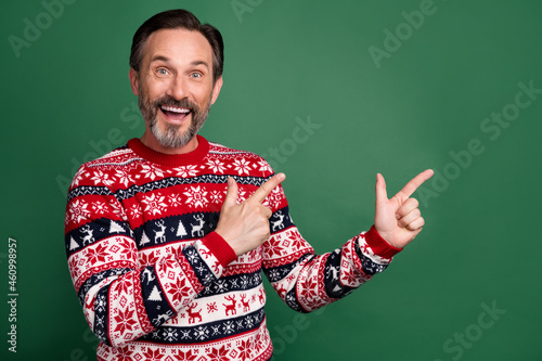 Photo of mature cool excited happy amazed man point finger empty space news index isolated on green color background