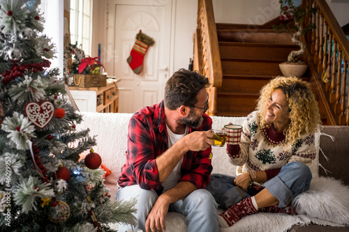 Happy couple toasting with coffee at home during Christmas photo