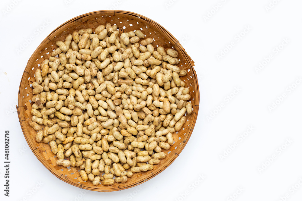 Raw peanuts in bamboo basket on white background. Raw peanuts in bamboo basket on white background.
