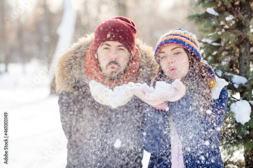 Photo of young attractive couple have fun walk forest winter blow air snow you vacation holiday romance photo