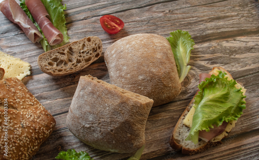 Bread, fresh baked goods and herbs, ham rolls Bread, fresh baked goods and herbs, ham rolls