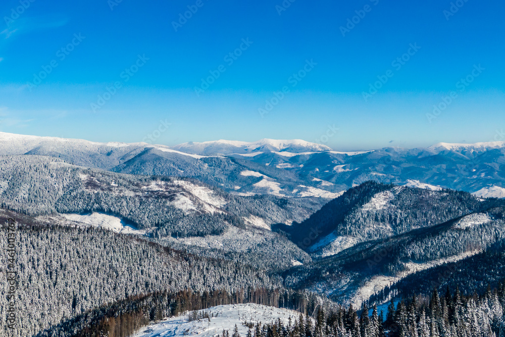 mountain peaks covered with snow on a bright sunny day against the blue sky. winter landscape. panorama of the snowy mountains