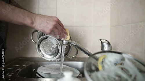 male hands washing dishes in the kitchen
