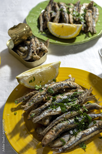 Grilled fish served on plate with lemon and herbs photo