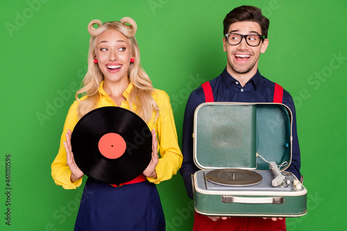 Photo of shocked beautiful young guy lady wear pin up clothes holding vinyl player disk isolated green color background