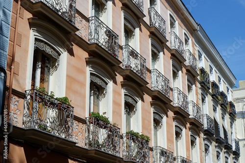 Classical vintage building facades with elegant metallic balconies in Chueca district dowtown Madrid, Spain photo