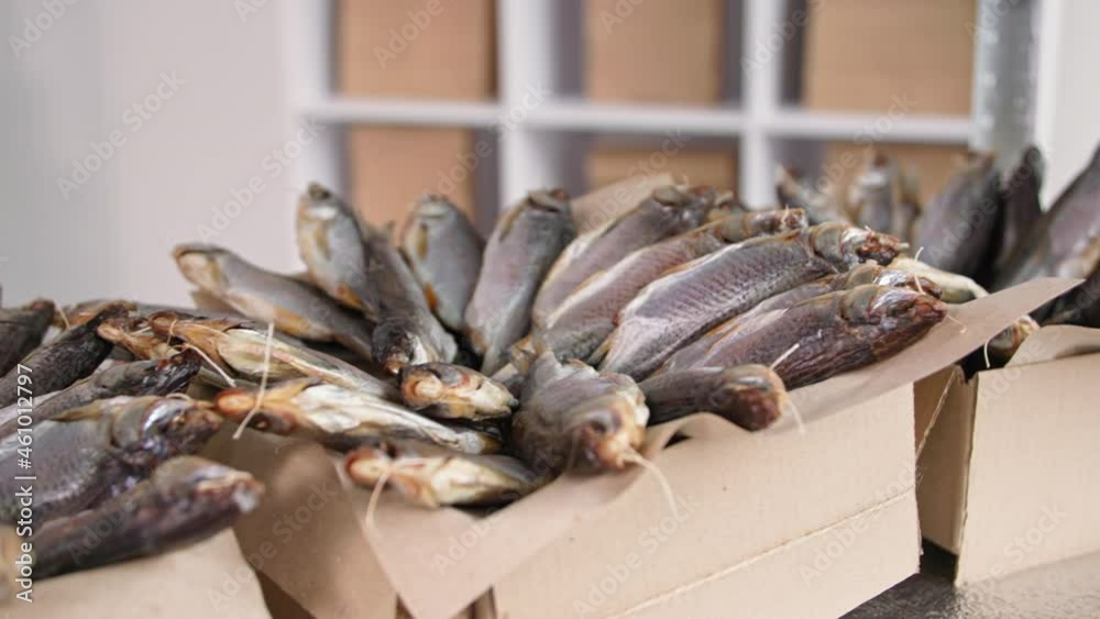 catching and cooking fish, tasty salted sea roach in cardboard boxes on