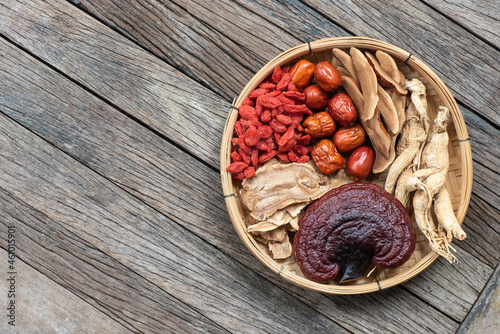Ginseng, lingzhi mushroom, goji berry, red jujube and tea on  an old wooden background.top view,flat lay.